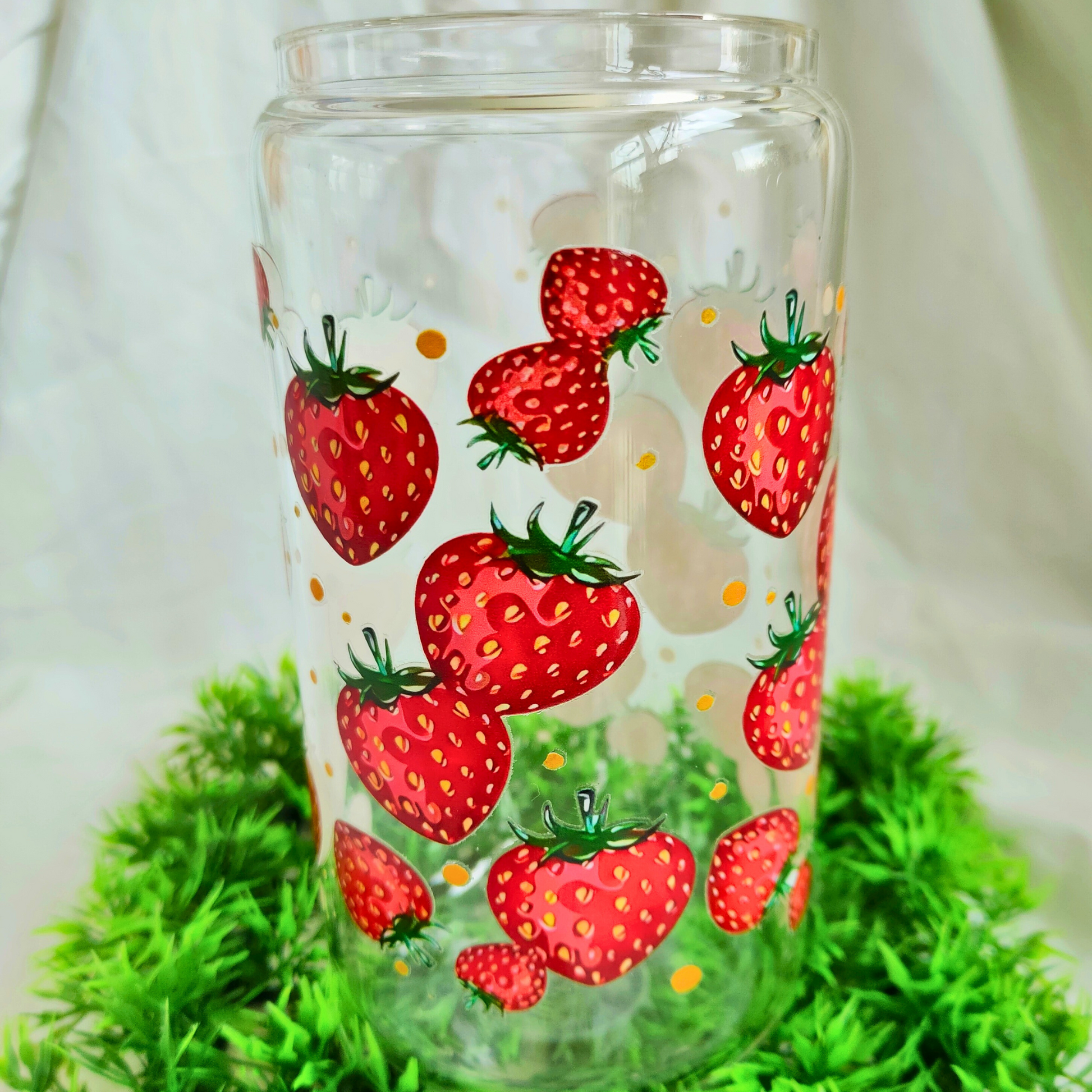 clear glass cup with strawberry print.
